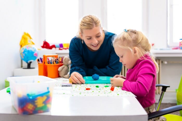 Child using playdo at therapy